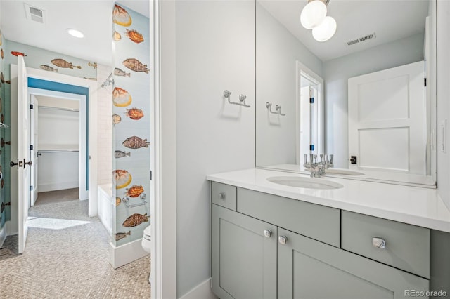 full bath featuring visible vents, toilet, vanity, and baseboards
