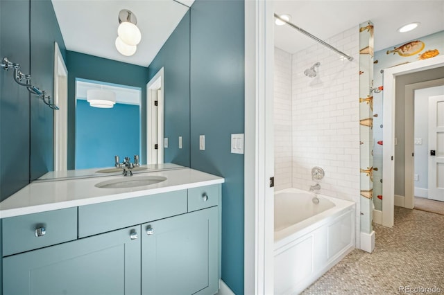 full bathroom with vanity, baseboards, and shower / washtub combination