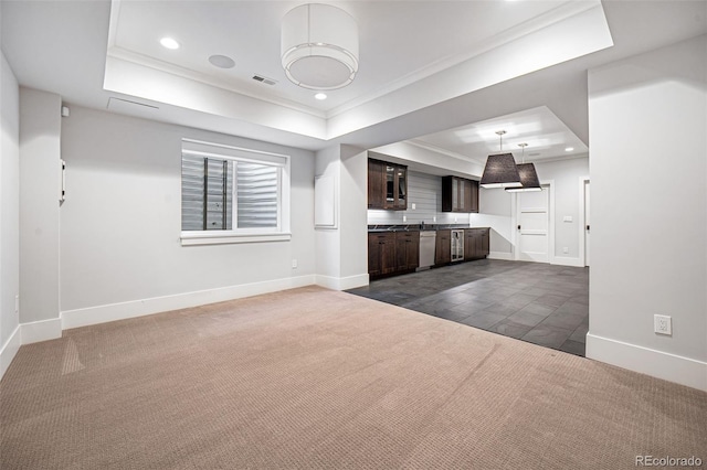 interior space with dark carpet, visible vents, a raised ceiling, and recessed lighting