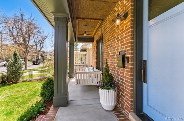 view of patio / terrace with a porch and fence