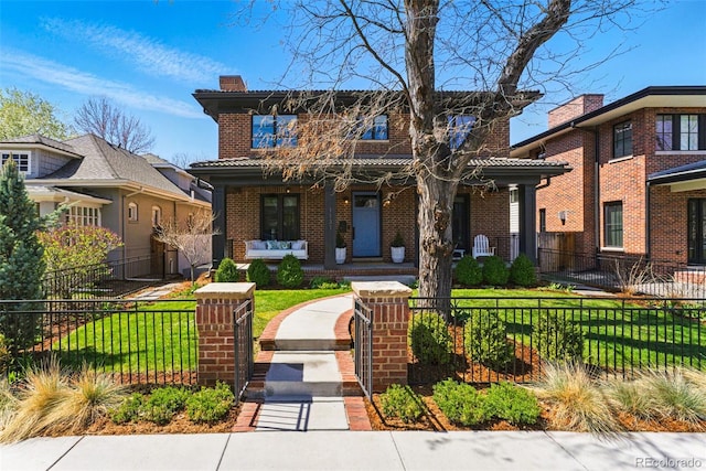 view of front of house featuring brick siding, a porch, and a fenced front yard