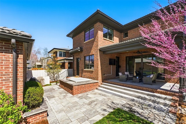 1131 S York St, Denver, CO 80210 - rear view of house featuring a patio area, outdoor lounge area, brick siding, and fence
