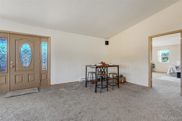 dining space featuring carpet flooring, lofted ceiling, and baseboard heating