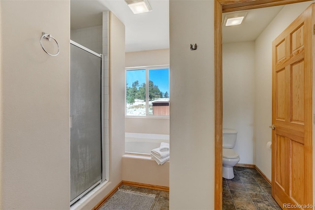 bathroom featuring plus walk in shower and toilet