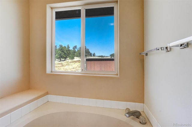 bathroom with a tub to relax in