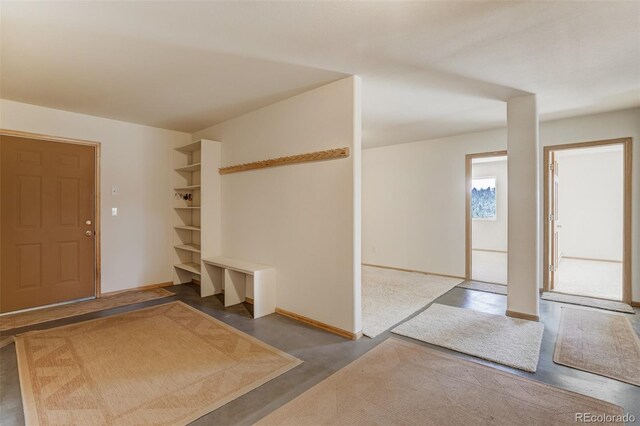 foyer entrance featuring concrete floors