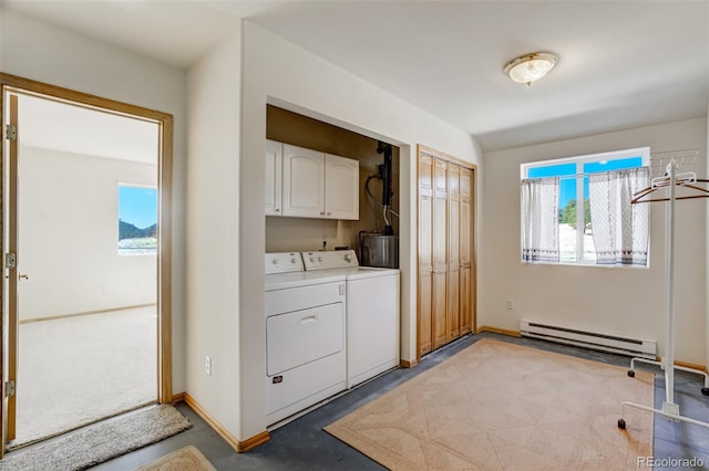 washroom with baseboard heating, cabinets, water heater, and washer and dryer