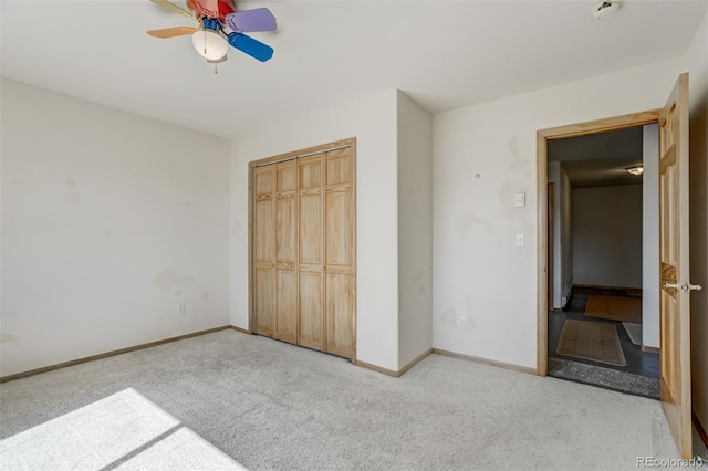 unfurnished bedroom with light carpet, a closet, and ceiling fan