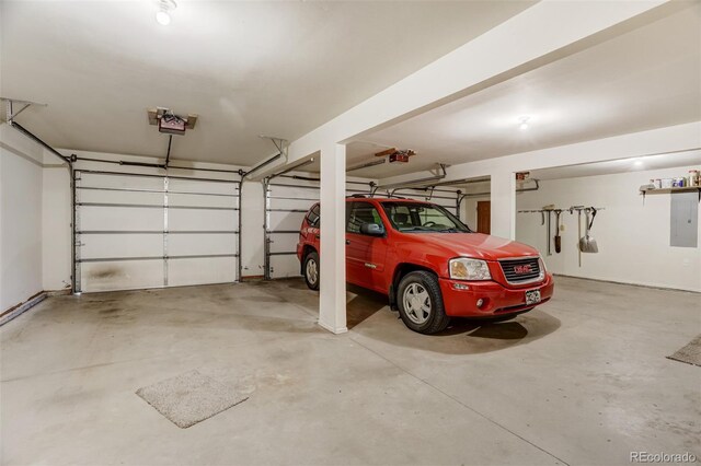 garage with electric panel and a garage door opener