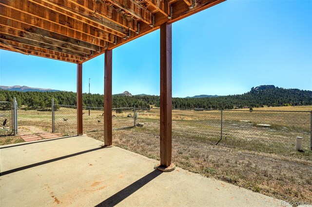 view of patio featuring a mountain view and a rural view