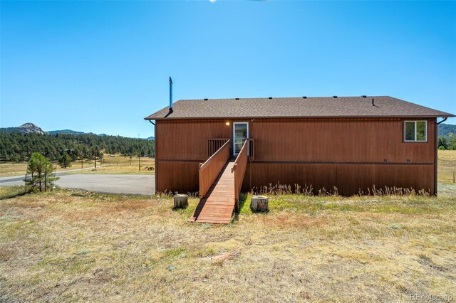 back of property with a mountain view