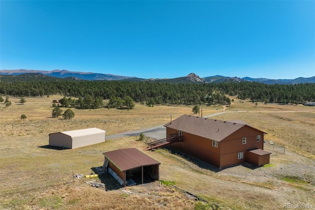 drone / aerial view featuring a mountain view and a rural view