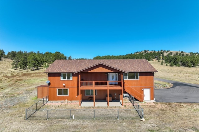 back of house with a deck