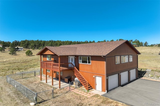 view of front of property featuring a deck and a garage