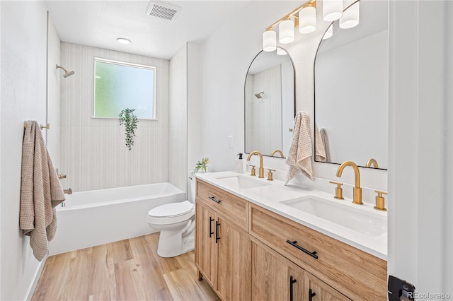 261 Knox Ct, Denver, CO 80219 - bathroom with double vanity, washtub / shower combination, and wood finished floors