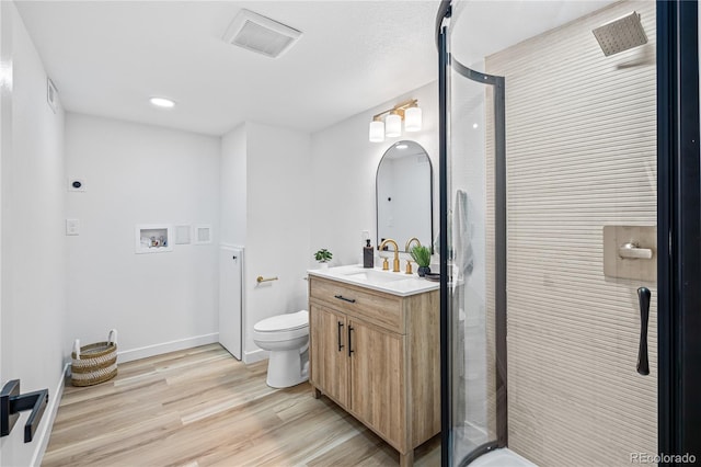 261 Knox Ct, Denver, CO 80219 - full bath with vanity, a shower stall, wood finished floors, and recessed lighting