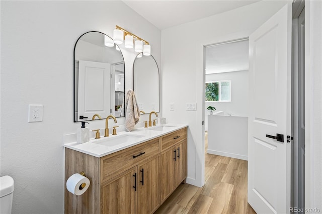261 Knox Ct, Denver, CO 80219 - bathroom featuring wood finished floors and double vanity