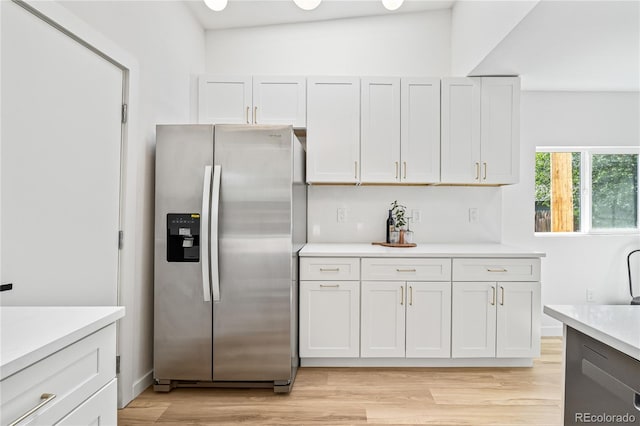 261 Knox Ct, Denver, CO 80219 - kitchen featuring stainless steel fridge with ice dispenser, light countertops, light wood-style floors, and white cabinetry