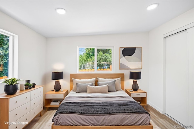261 Knox Ct, Denver, CO 80219 - bedroom featuring light wood-type flooring, multiple windows, and recessed lighting