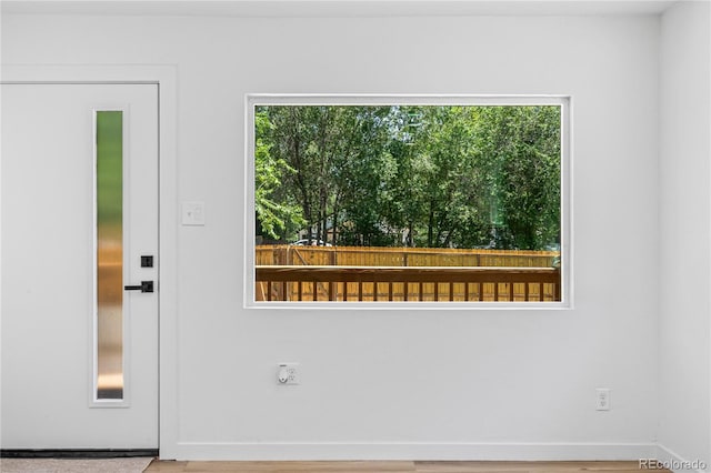 261 Knox Ct, Denver, CO 80219 - doorway to outside with healthy amount of natural light and wood finished floors