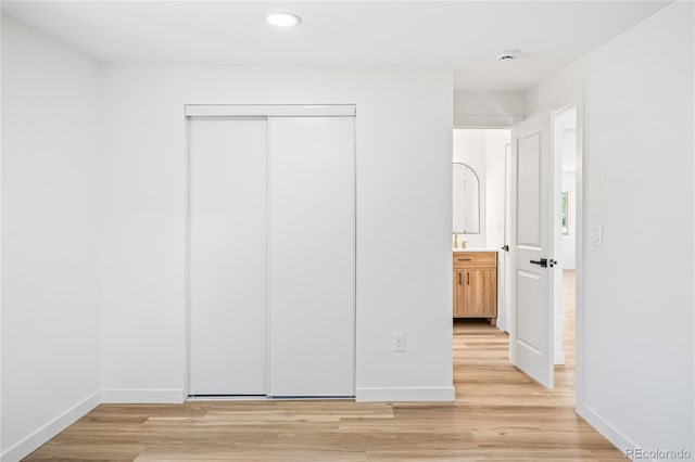 261 Knox Ct, Denver, CO 80219 - unfurnished bedroom featuring light wood-style flooring, a closet, and recessed lighting