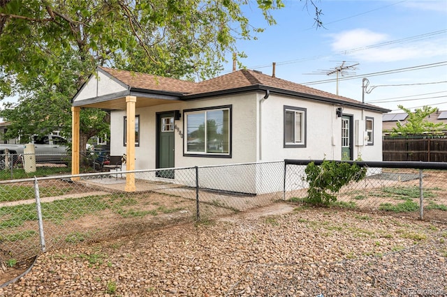 6980 Niagara St, Commerce City, CO 80022 - view of front of home with stucco siding, roof with shingles, and a fenced backyard