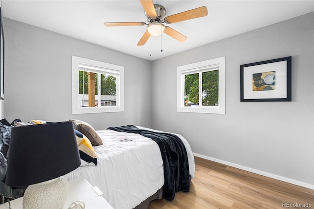 6980 Niagara St, Commerce City, CO 80022 - bedroom featuring multiple windows, baseboards, wood finished floors, and ceiling fan