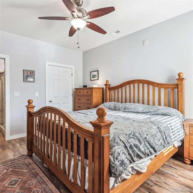 bedroom with ceiling fan and wood-type flooring