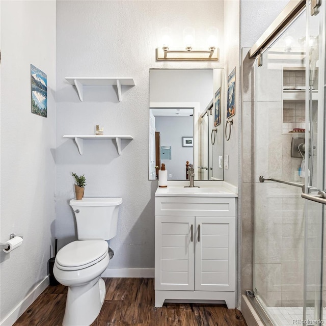 bathroom with vanity, wood-type flooring, toilet, and walk in shower