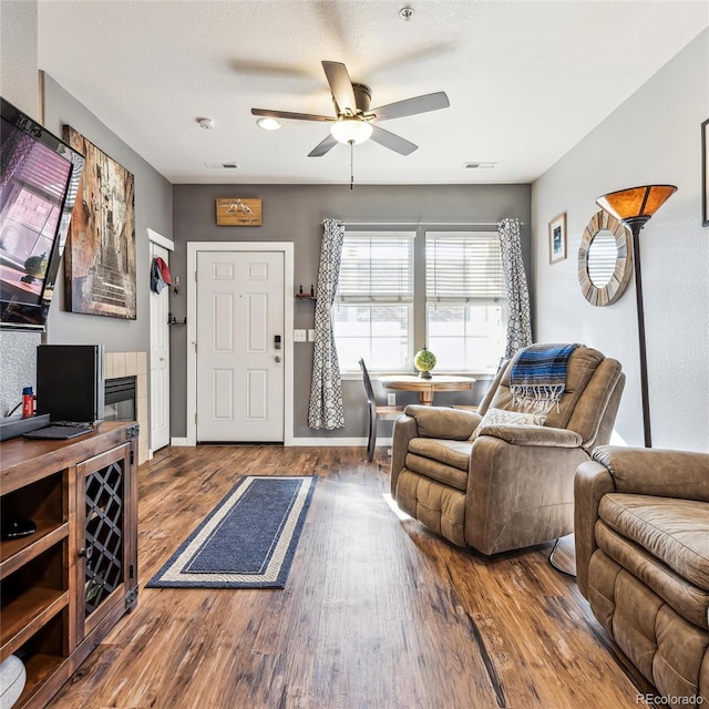 living room featuring hardwood / wood-style floors and ceiling fan