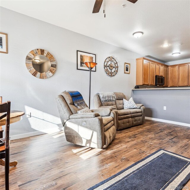 living room featuring light hardwood / wood-style flooring and ceiling fan