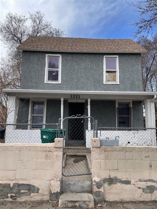 view of front of home featuring a fenced front yard, covered porch, a shingled roof, a gate, and stucco siding