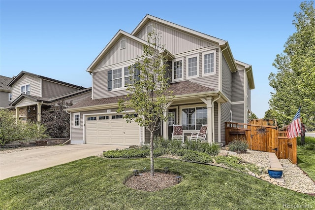 2115 Coach House Loop, Castle Rock, CO 80109 - view of front of property with driveway, an attached garage, board and batten siding, and covered porch