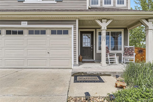 2115 Coach House Loop, Castle Rock, CO 80109 - view of exterior entry with a porch, an attached garage, and driveway