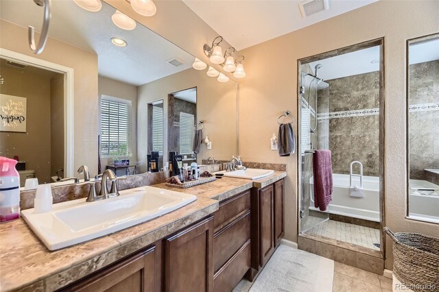2115 Coach House Loop, Castle Rock, CO 80109 - full bath featuring a tile shower, double vanity, a bath, tile patterned floors, and toilet