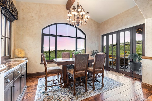 dining space featuring a notable chandelier, high vaulted ceiling, and hardwood / wood-style flooring