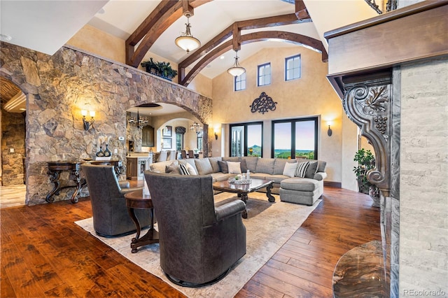 living room featuring beam ceiling, high vaulted ceiling, french doors, and wood-type flooring