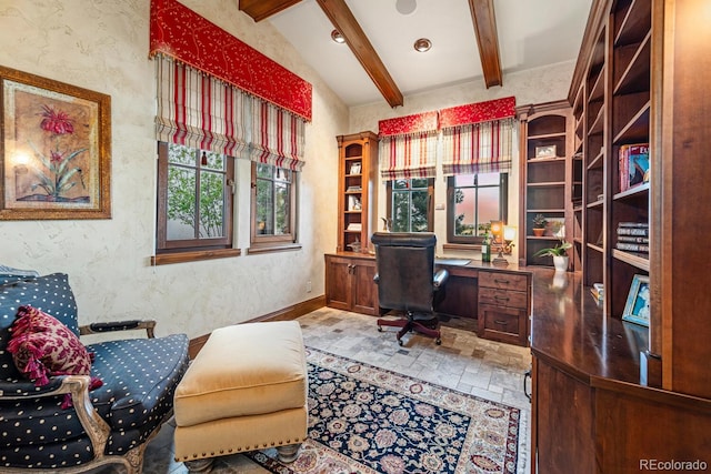 tiled office space with built in desk and lofted ceiling with beams