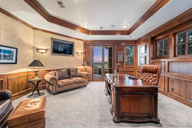 office featuring a tray ceiling, ornamental molding, and light colored carpet