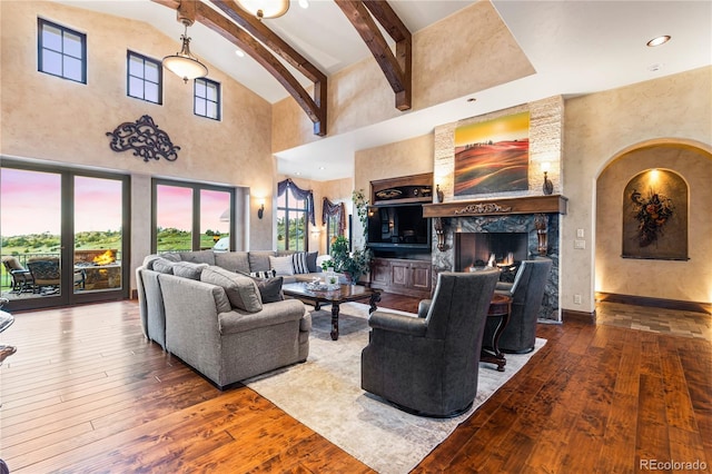 living room with a premium fireplace, high vaulted ceiling, and hardwood / wood-style flooring