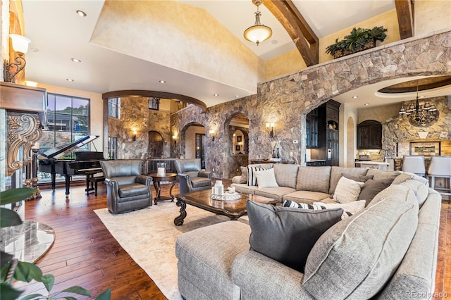 living room with beamed ceiling, a towering ceiling, and dark hardwood / wood-style flooring