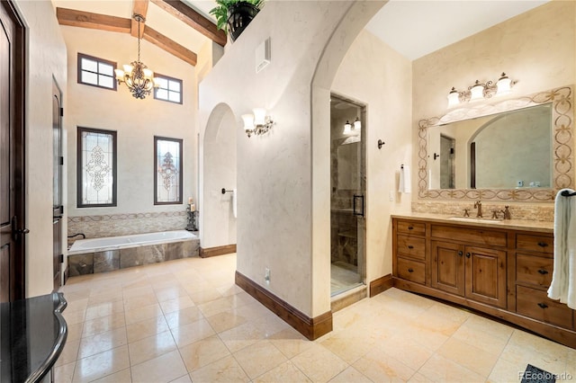 bathroom with plus walk in shower, an inviting chandelier, beamed ceiling, tile floors, and oversized vanity