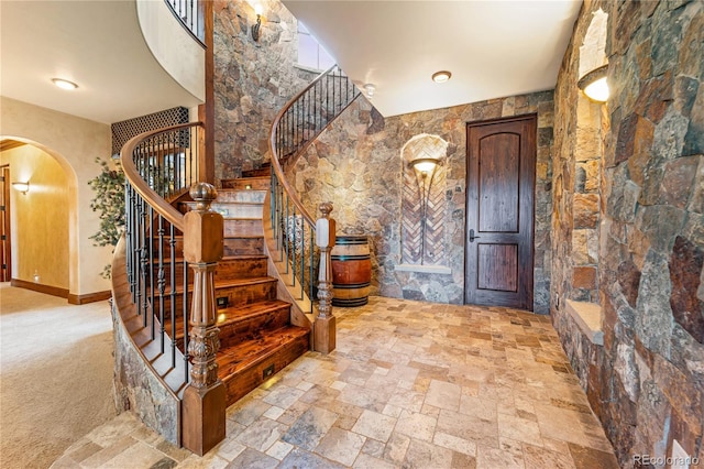 foyer featuring light carpet