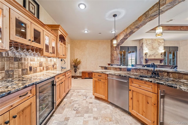 kitchen featuring hanging light fixtures, dark stone countertops, wine cooler, and stainless steel dishwasher