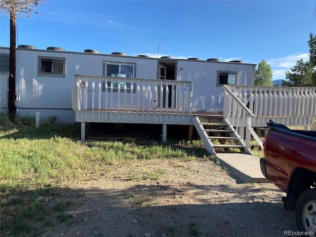 back of house with a wooden deck