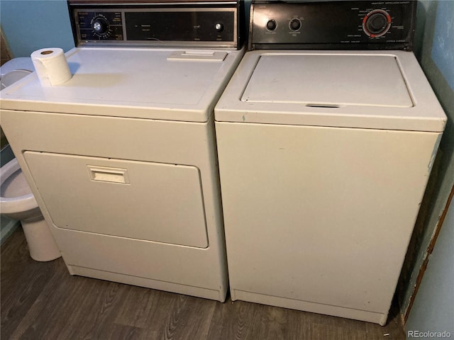 laundry area featuring laundry area, wood finished floors, and washer and dryer