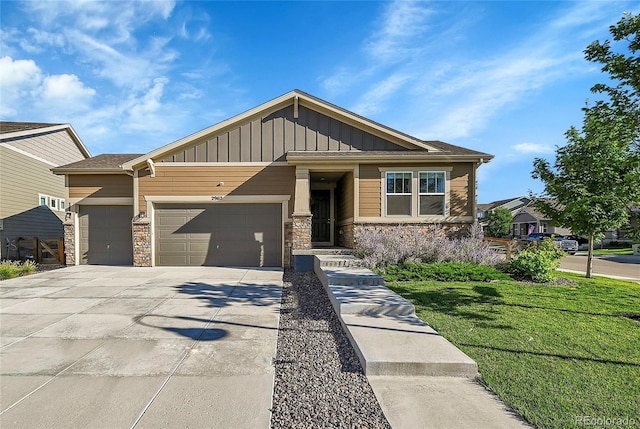 craftsman-style house with driveway, stone siding, an attached garage, board and batten siding, and a front yard