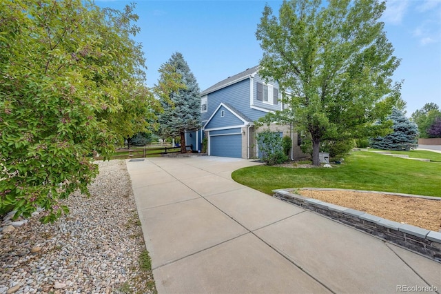 view of home's exterior featuring a lawn, an attached garage, and driveway