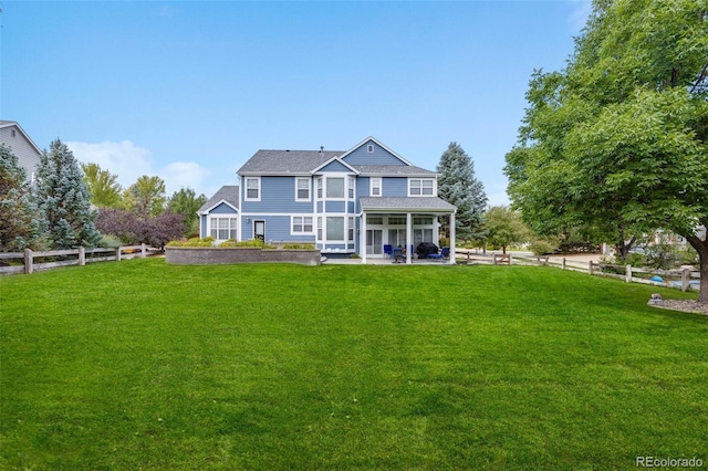 back of house with a fenced backyard, a patio area, and a yard