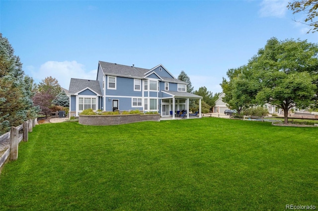 back of property featuring a yard, fence, and a patio area